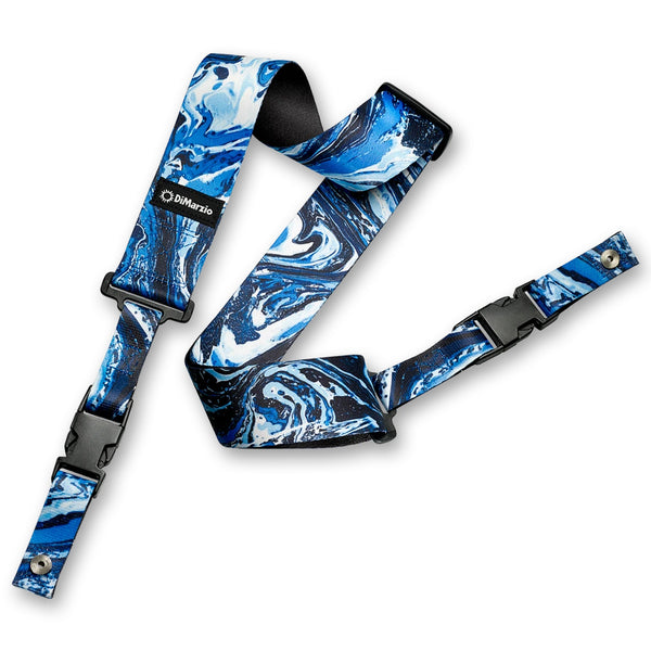 Image of an abstract colorful clip lock guitar strap against white background. the guitar strap clips together with black clips and has a small black patch that says "DiMarzio". the strap is a teal, dark blue, and white abstract marbled pattern.