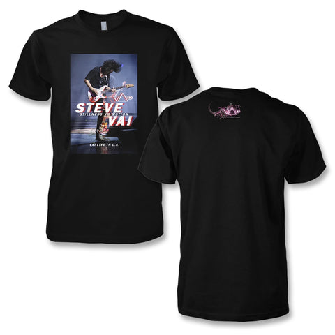 Black T-Shirt on a white background. T-Shirt shows a picture of Steve Vai playing his guitar wildly. It is the cover of the "Stillness In Motion" album and DVD. On the back of the shirt, small between the shoulder blades, is the Vai logo in pink and white surrounded my stars.