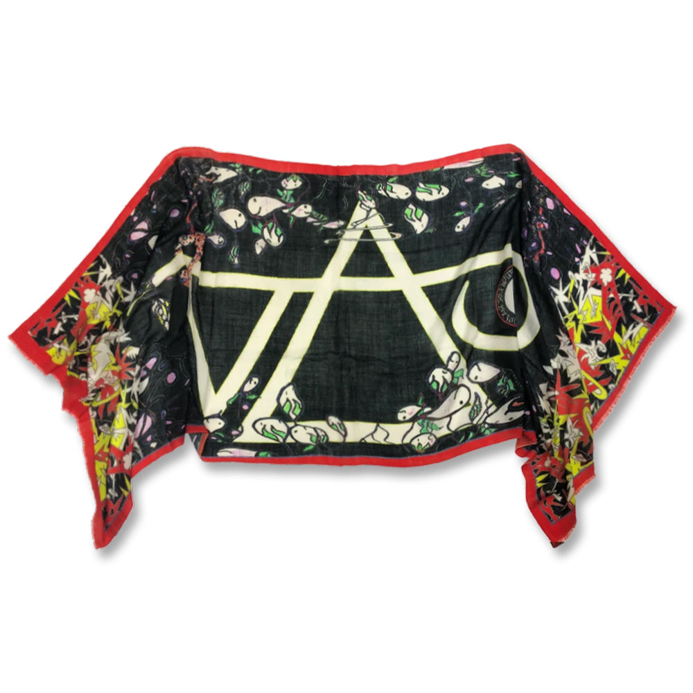 Image of the steve vai art scarf against white background. the scarf is outlined in orange and the center features a large white steve vai logo. The steve vai logo makes the word "vai" with an upside down triangle, a right side up one, and a line going across the triangles with a curl at the end next to the triangle that is upright.  around this are colorful abstract designs in the colors orange, white, yellow, green, and black. 