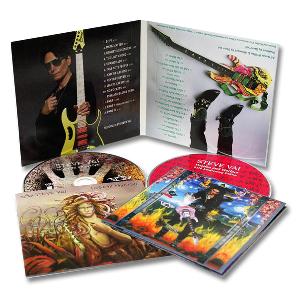 image of a cd case that is standing up, opened, and two cd cases with cds sticking out of them on the ground against a white background. the cds are modern primitive and passion and warfare by steve vai.  the opened cd case shows a photo of steve vai in all black, holding a guitar forward towards the camera. the other side shows a colorful guitar lying on the ground. the cds below this are colorful album art of steve vai, and one of a graphic of a character.