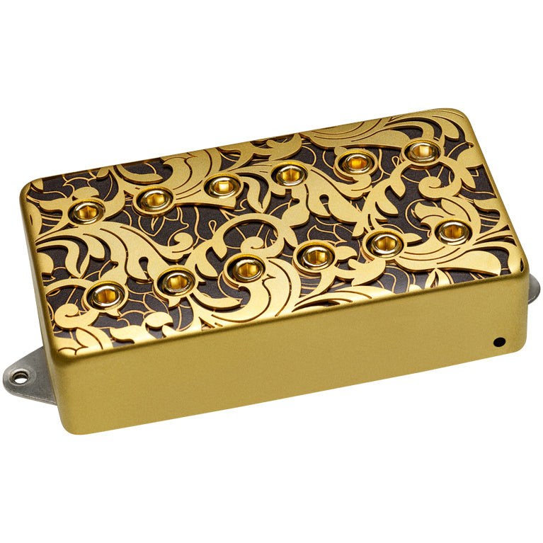 image of a gold guitar pickup with black and gold swirling design on the top of the pickup. the background of this image is white.