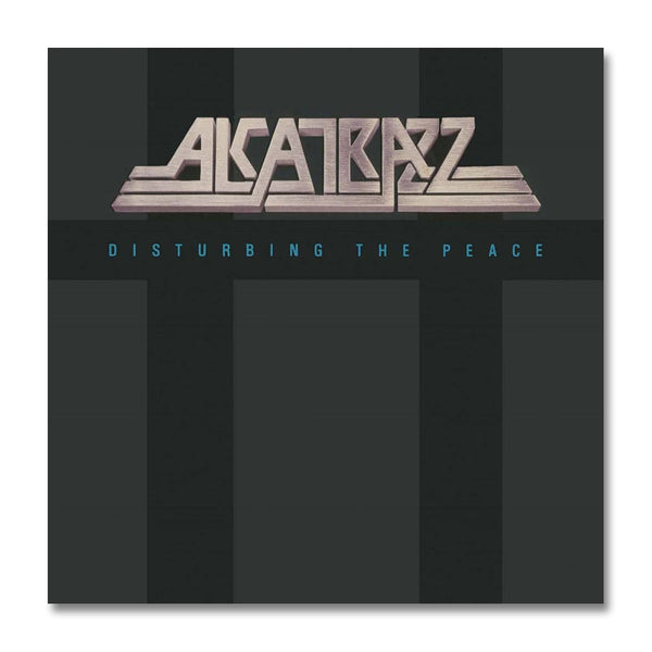 Image of the steve vai alcatrazz album artowrk. It says "alcatrazz" across the top in a silver color, lots of the letters have long tails on them. Below this in green text reads "disturbing the peace". the artwork background is a light and dark grey, and this album art is displayed against a white background.