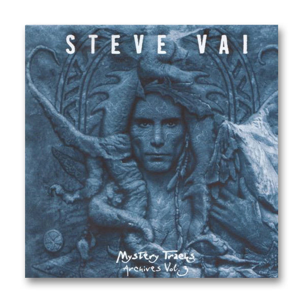 album artwork for steve vai- mystery tracks archives volume 3 against white background. the artwork is blue and features an image of a person staring at the camera, surrounded by abstract shapes and symbols. across the top in white text reads "steve vai". the center of the bottom in white reads "mystery tracks, archives vol. 3".
