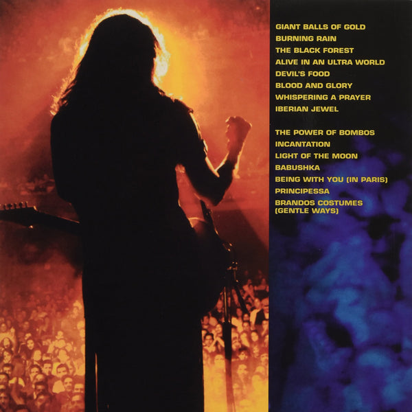 back of the steve vai "alive in an ultra world" album artwork.  the left of the back has an image of steve standing with his guitar, facing a crowd, back to the camera. it is a yellow and orange colored image. the right features the tracklisting to the album in gold text. 