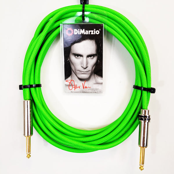 image of a neon green guitar cable with gold ends against white background. the black cable has a tag that features a black and white photo of steve vai, photographed from the neck up. above steve's head reads "dimarzio" in white text. below steve in red cursive are the words "steve vai".