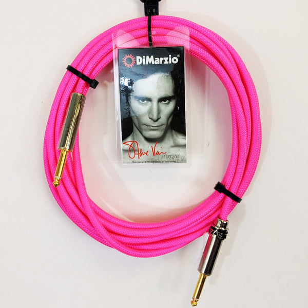 image of a neon pink guitar cable with gold ends against white background. the black cable has a tag that features a black and white photo of steve vai, photographed from the neck up. above steve's head reads "dimarzio" in white text. below steve in red cursive are the words "steve vai".