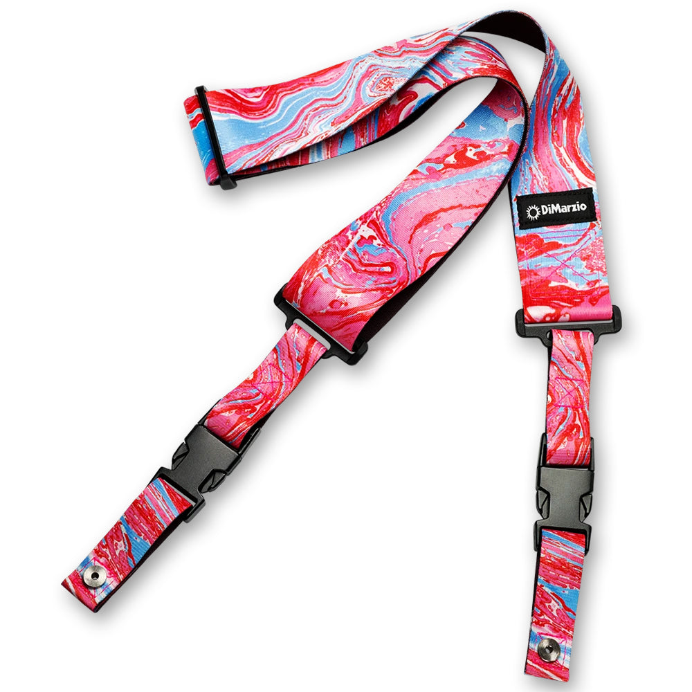 Image of an abstract colorful clip lock guitar strap against white background. the guitar strap clips together with black clips and has a small black patch that says "DiMarzio". the strap is a pink, blue, and white abstract marbled pattern.