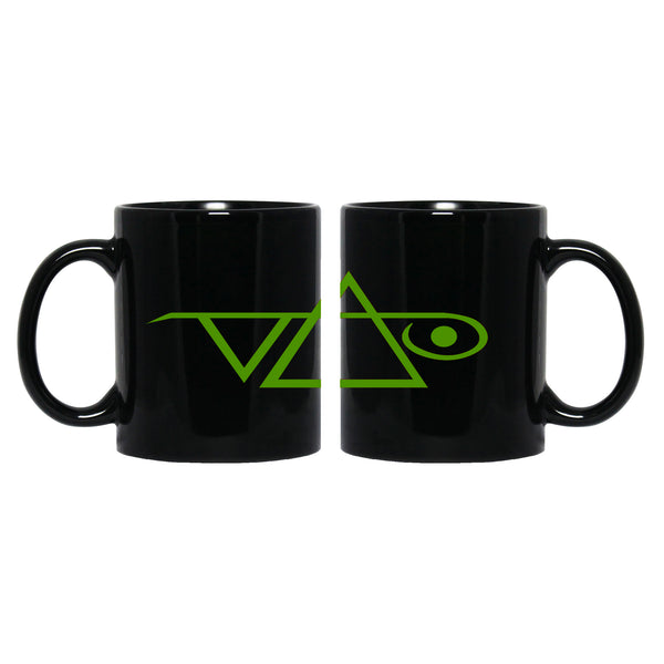 Image of a black coffee mug against white background. the mug has the steve vai logo in it in green.  The steve vai logo makes the word "vai" with an upside down triangle, a right side up one, and a line going across the triangles with a curl at the end next to the triangle that is upright. 
