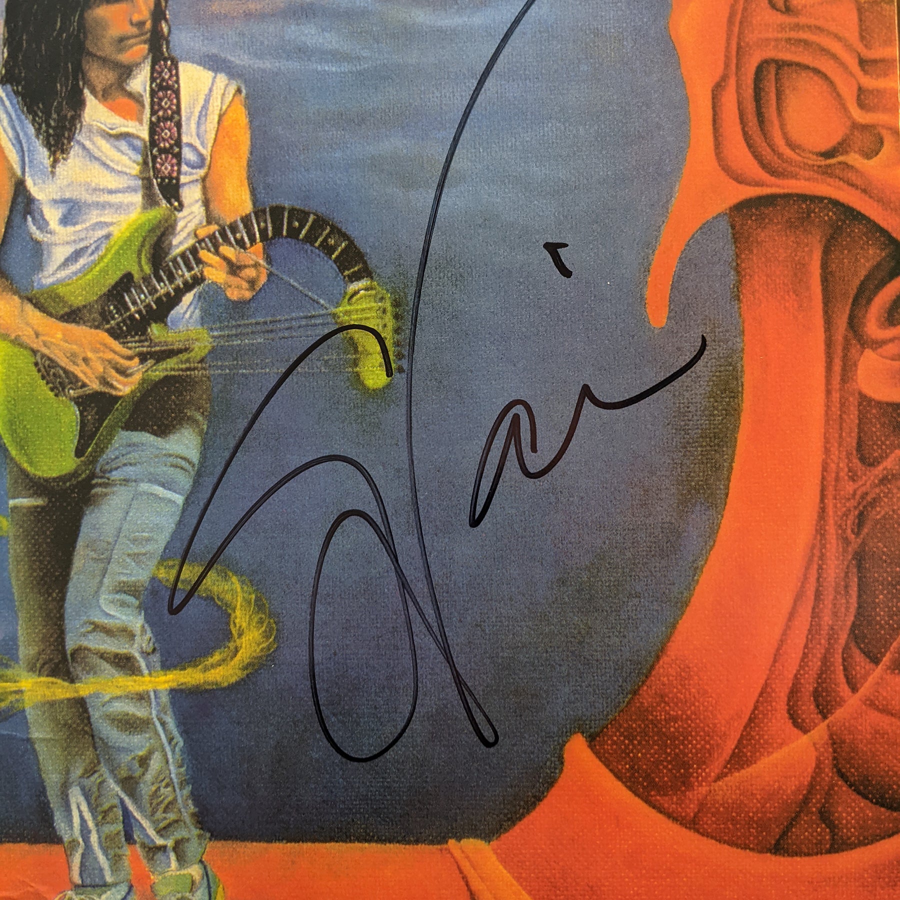 close up image of the steve vai flex-able vinyl lp. the close up is on steve vai's signature in black to show that the album is signed. 