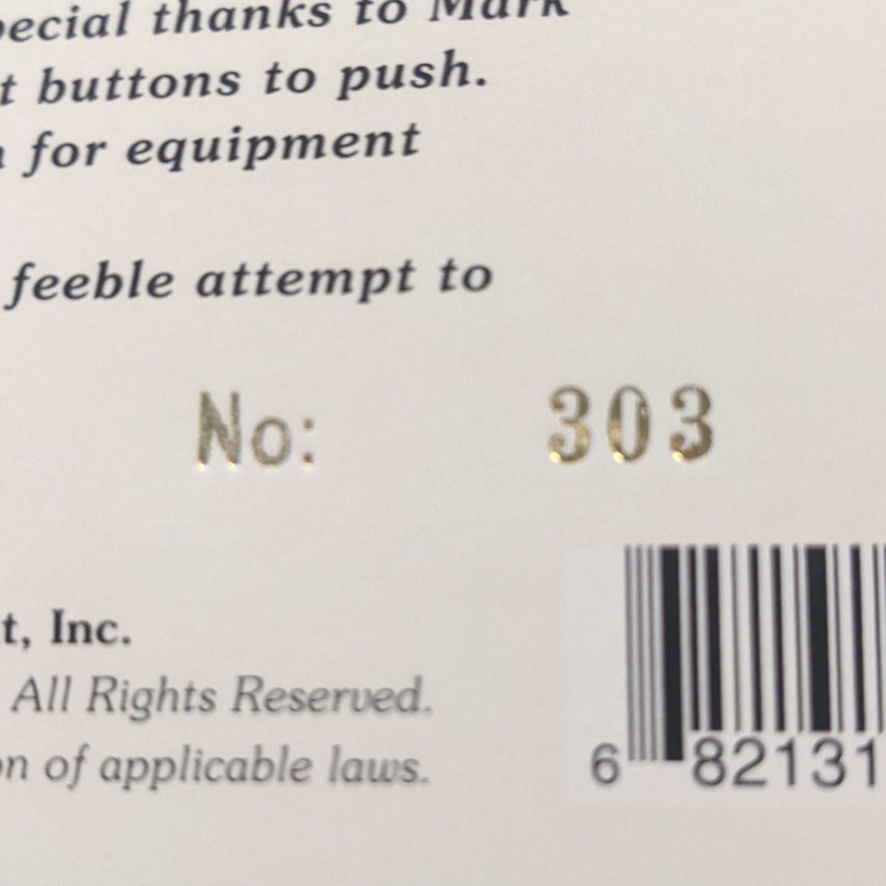 up close image of the back of the vinyl sleeve with the bar code showing and the number that the vinyl is. this is white with black text.