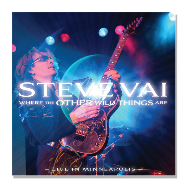 Image of the steve vai where the other wild things are live in minneapolis album artwork. it is a blue and red image of steve vai on stage, playing guitar. the guitar is being held up in the air while he plays. across the image in white text reads "steve vai, where the other wild things are". the bottom of the artwork in white text reads "live in minneapolis".