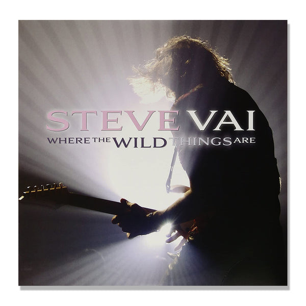 steve vai album artwork against white background. image of steve vai facing away from camera, playing guitar on stage. a white stage light shines on him. across this image in pink, white, and black text reads "where the wild things are".