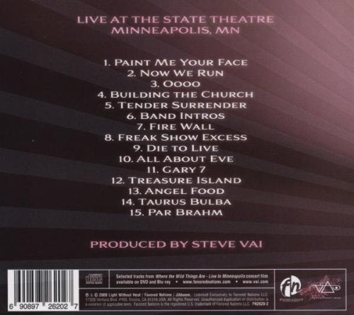 back of the album artwork for where the wild things are. there is a pink, faded white and faded black striped pattern on the back. in pink text reads "live at the state theatre, minneapolis, MN". below that in white text is the tracklisting for the album in white text. below that in pink reads "produced by steve vai".