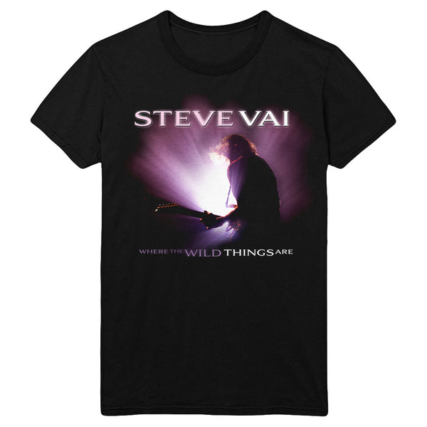 black tshirt against white background. across the shirt in white text says "steve vai". below is a white and purple image of steve vai playing guitar on stage with a bright purple and white light shining on him. below this in purple and white text reads "where the wild things are".