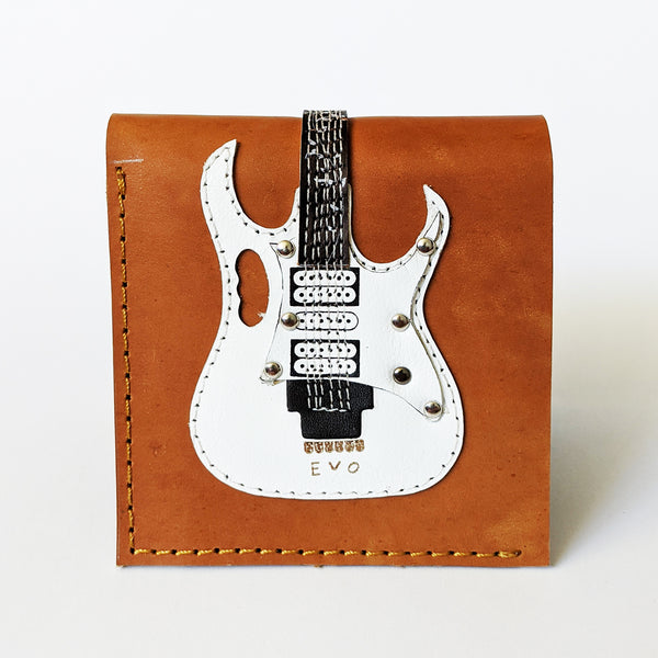 Image of a brown leather wallet with a white electric guitar wrapped on the wallet. 