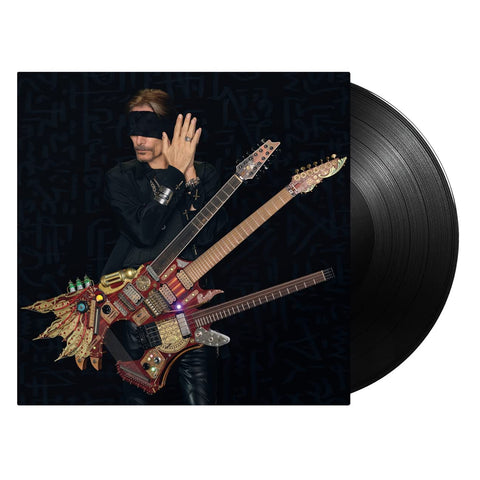 image of a vinyl sleeve with a black vinyl sticking halfway out of the sleeve against a white background. the vinyl sleeve features an image of steve vai wearing all black and wearing a black blindfold. his hands are pressed together by his ear. he has a guitar with three necks attached to him.