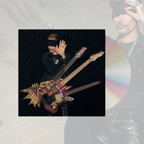 image of cd cover album art with a cd sticking halfway out of the case against a transparent white background with steve vai standing faded in the background. the album artwork features an image of steve vai wearing all black and wearing a black blindfold. his hands are pressed together by his ear. he has a guitar with three necks attached to him.